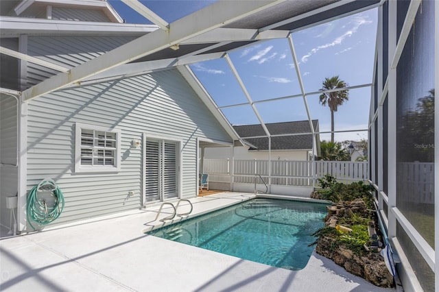 view of swimming pool featuring a lanai and a patio area