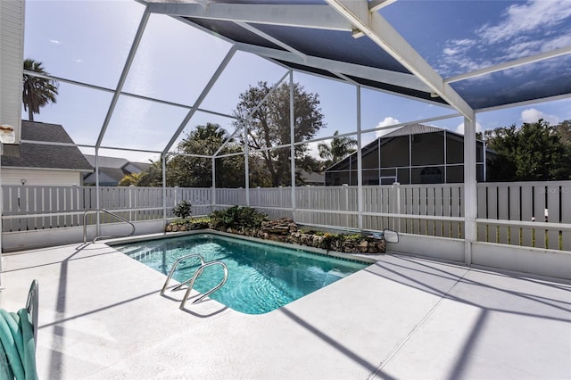 view of swimming pool featuring a lanai and a patio