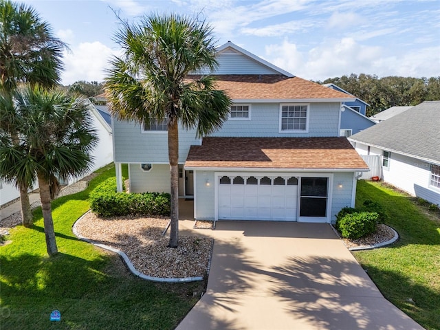 view of front of house with a garage and a front yard