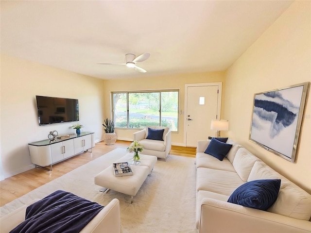 living room featuring ceiling fan and light wood-type flooring