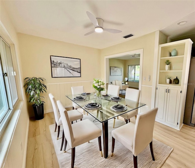 dining room with light wood-type flooring and ceiling fan