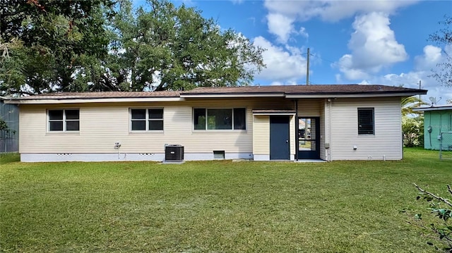 back of house with a lawn and central AC unit