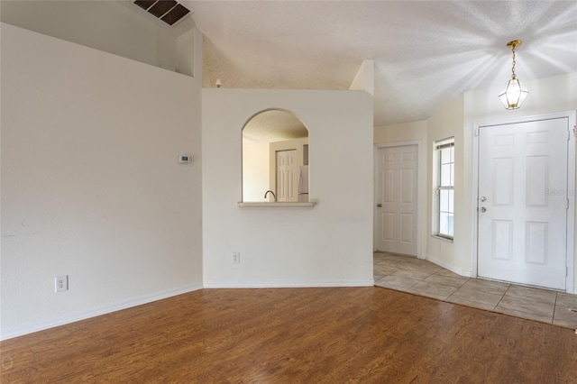 entrance foyer featuring wood-type flooring and a textured ceiling