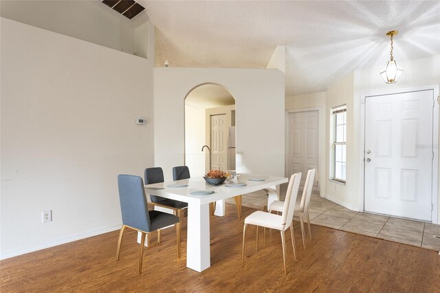 30 Sergeant Ct, Palm Coast, FL 32164 - dining space featuring arched walkways, wood finished floors, and baseboards
