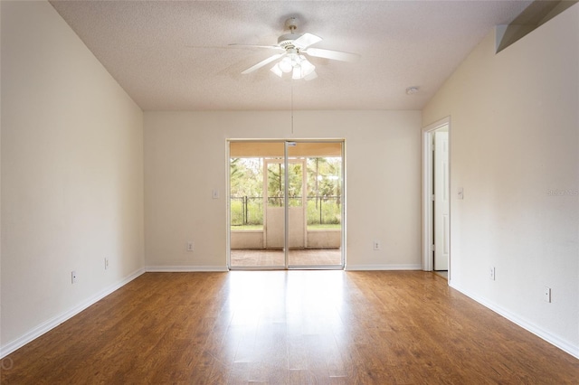 empty room featuring a textured ceiling, hardwood / wood-style flooring, and ceiling fan