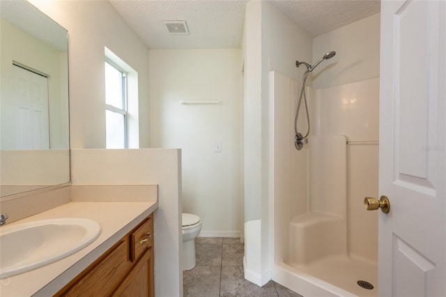 bathroom with walk in shower, a textured ceiling, and toilet