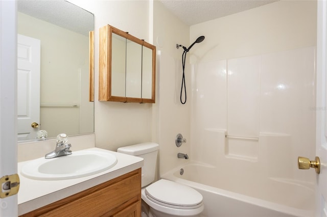 full bathroom with shower / washtub combination, a textured ceiling, toilet, and vanity