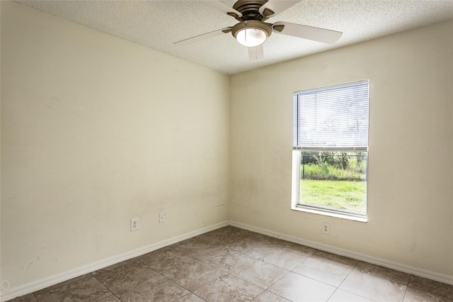 30 Sergeant Ct, Palm Coast, FL 32164 - empty room with a ceiling fan, baseboards, light tile patterned floors, and a textured ceiling