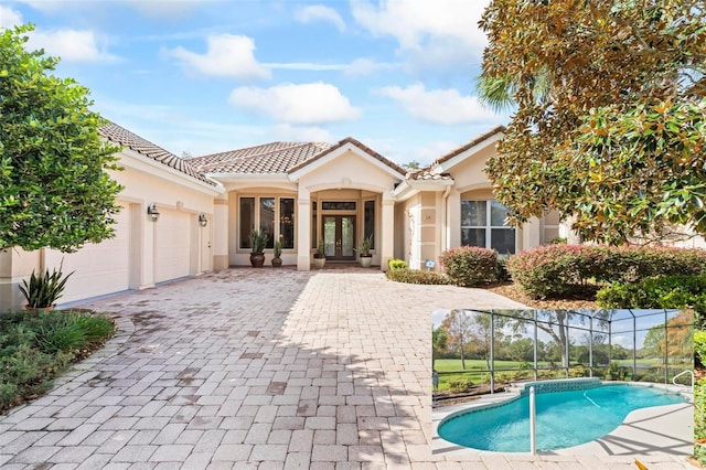 view of front of house with french doors and a garage