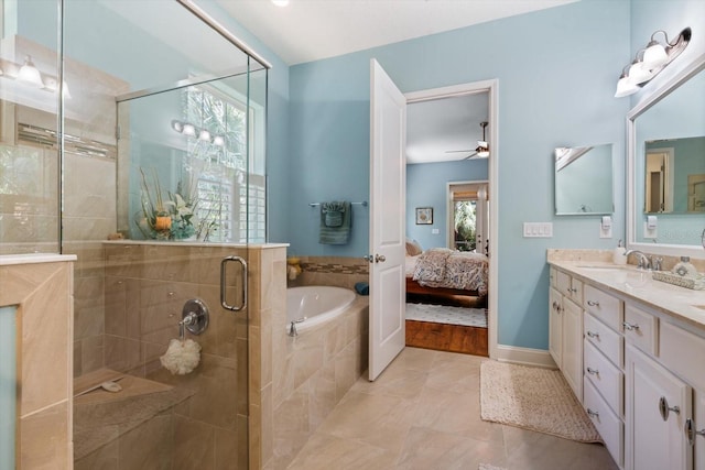 bathroom with shower with separate bathtub, ceiling fan, tile patterned floors, and vanity