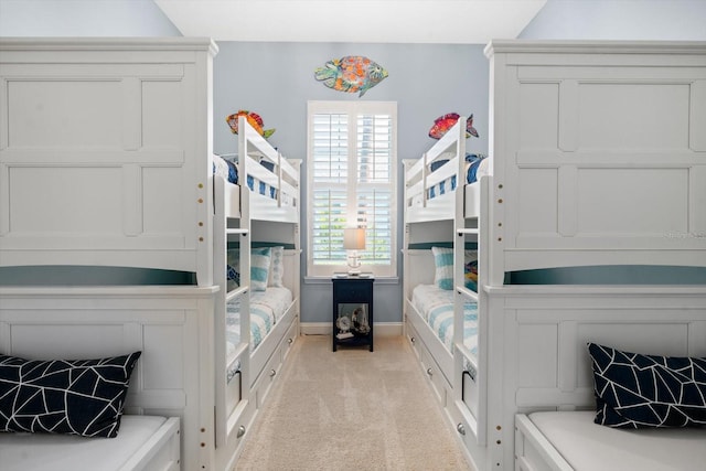 carpeted bedroom with lofted ceiling