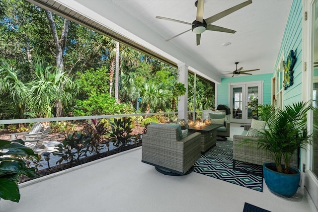 sunroom / solarium featuring french doors and ceiling fan