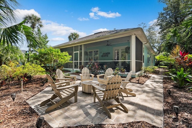 back of house with ceiling fan, a sunroom, and a patio area