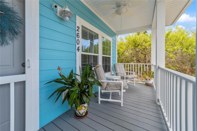 wooden terrace with covered porch and ceiling fan