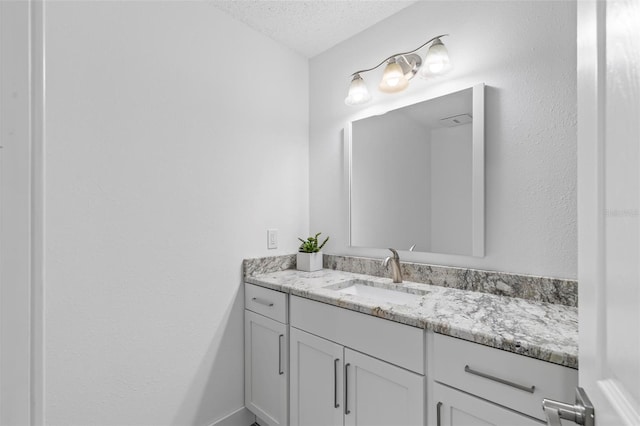 bathroom with vanity and a textured ceiling