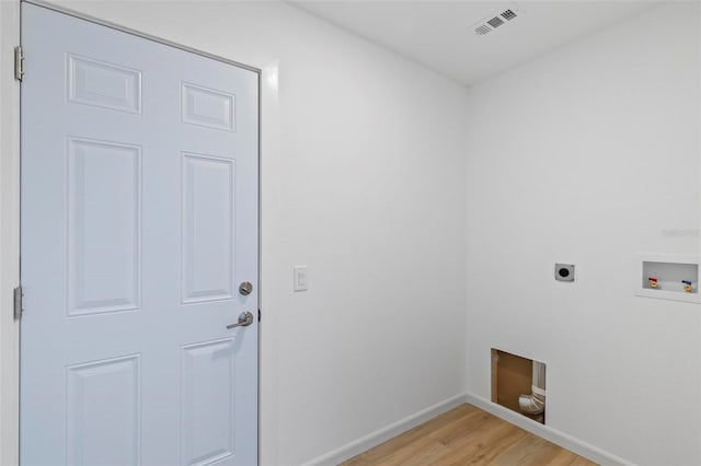 laundry room with hardwood / wood-style flooring, electric dryer hookup, and hookup for a washing machine