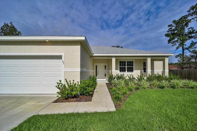 view of front of house with a garage, a front lawn, and a porch