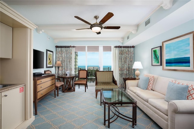 living room with ceiling fan and beamed ceiling