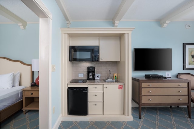 kitchen with black appliances, crown molding, backsplash, sink, and beamed ceiling