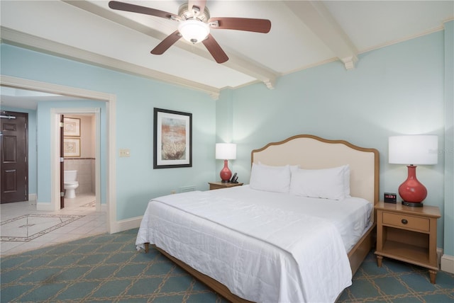 bedroom featuring connected bathroom, beamed ceiling, and ceiling fan