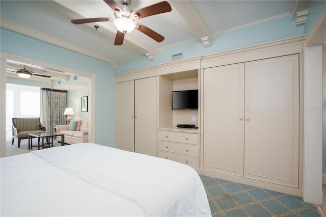 carpeted bedroom featuring beamed ceiling, ceiling fan, and crown molding