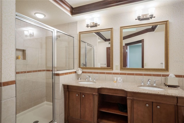 bathroom featuring a shower with door, a textured ceiling, decorative backsplash, and ornamental molding