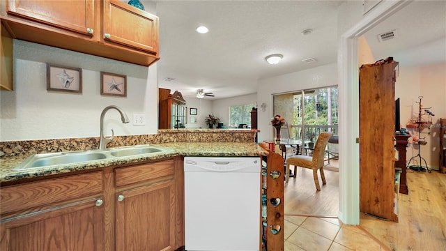 kitchen with light hardwood / wood-style floors, sink, kitchen peninsula, ceiling fan, and dishwasher