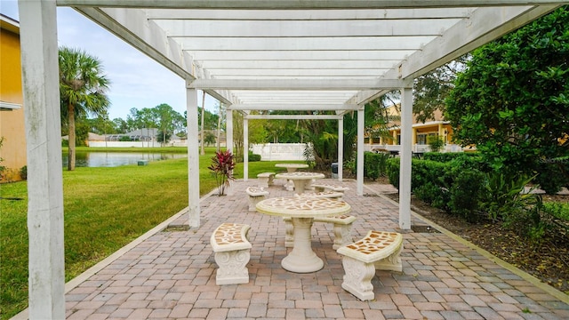 view of patio with a water view and a pergola