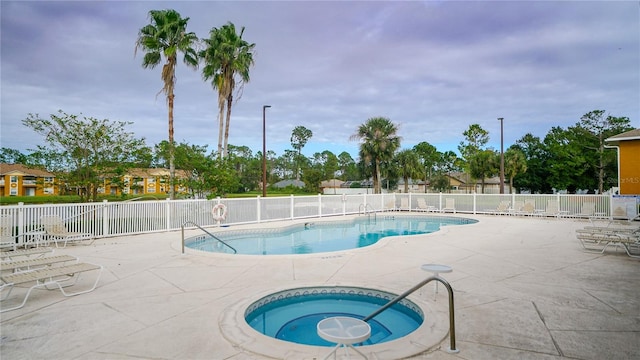 view of swimming pool with a community hot tub and a patio