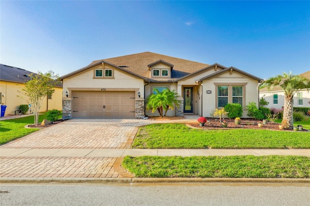 view of front of house with a garage and a front lawn