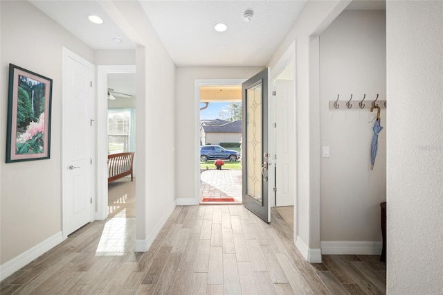 doorway to outside featuring wood finish floors, recessed lighting, and baseboards