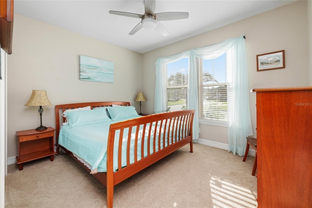 carpeted bedroom featuring ceiling fan and baseboards