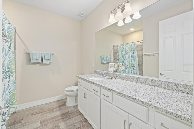 full bathroom with visible vents, baseboards, toilet, wood tiled floor, and vanity