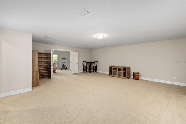 basement featuring carpet flooring, visible vents, and baseboards