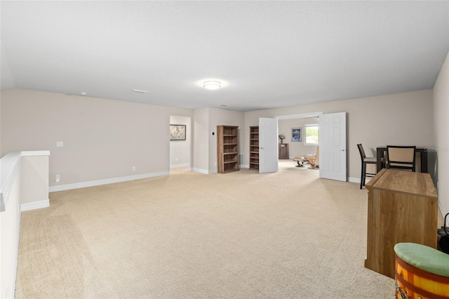 interior space featuring light carpet and baseboards