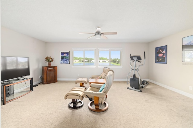 interior space featuring carpet floors, ceiling fan, and baseboards