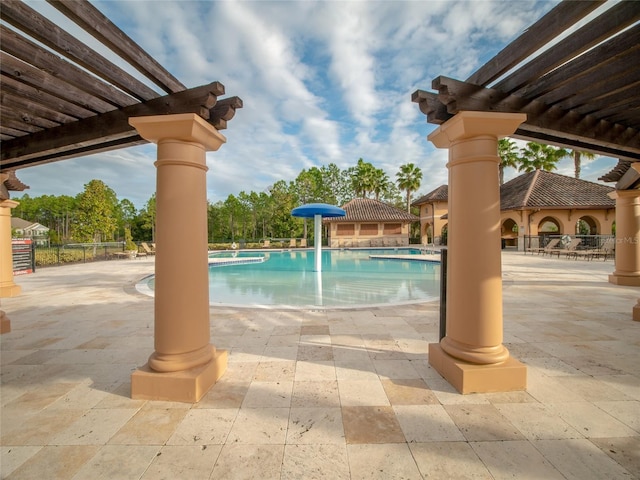 community pool featuring a pergola and a patio