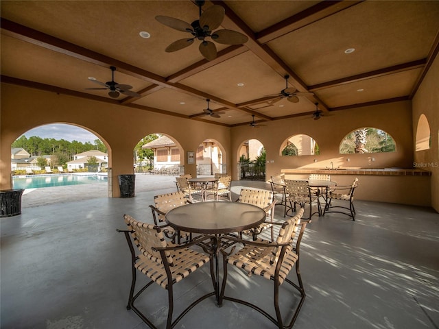 view of patio / terrace featuring exterior kitchen, outdoor dining area, and an outdoor pool