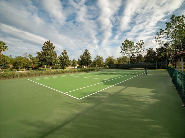 view of tennis court featuring fence