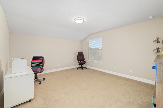 home office with vaulted ceiling, carpet floors, a textured ceiling, and baseboards