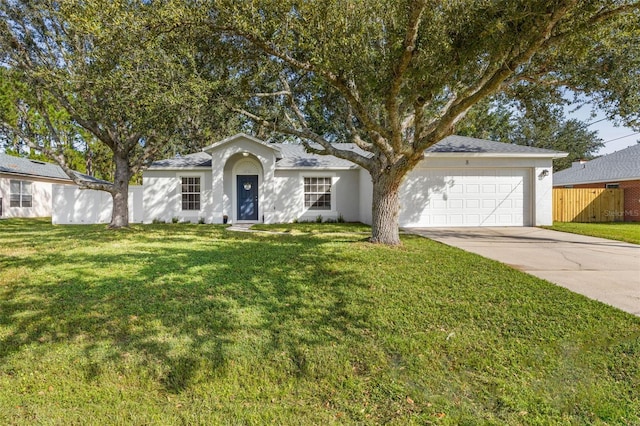 single story home with a garage and a front yard