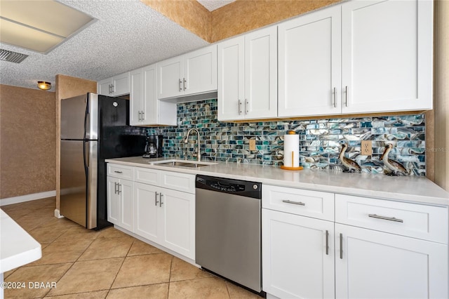 kitchen featuring white cabinetry, stainless steel appliances, a textured ceiling, and sink