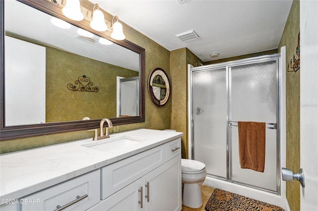 bathroom with vanity, tile patterned floors, an enclosed shower, and toilet