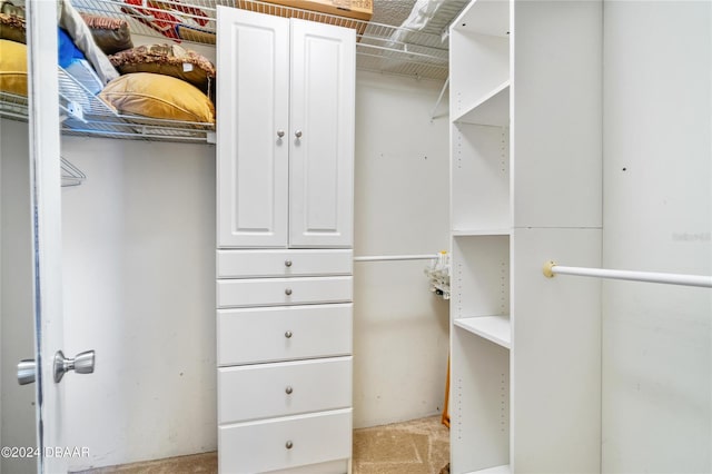 spacious closet featuring light carpet