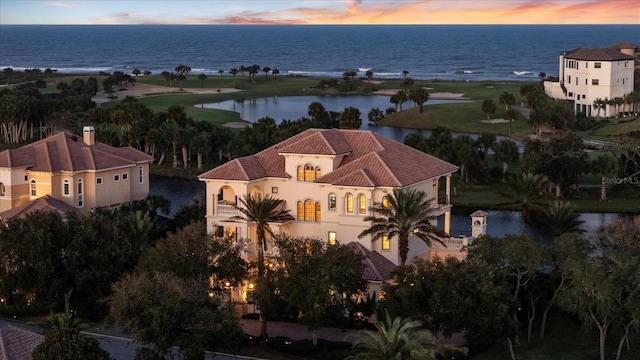 aerial view at dusk with a water view