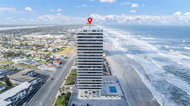 drone / aerial view with a water view and a beach view