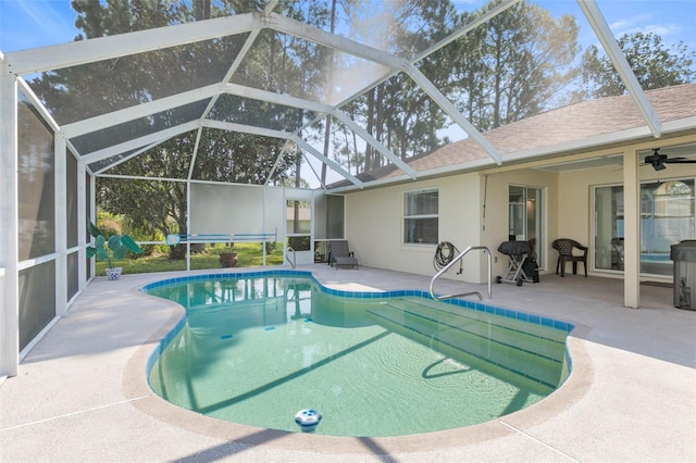 view of swimming pool with ceiling fan, a lanai, and a patio