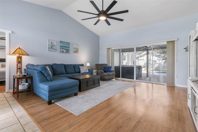 living room featuring vaulted ceiling, ceiling fan, and light hardwood / wood-style flooring