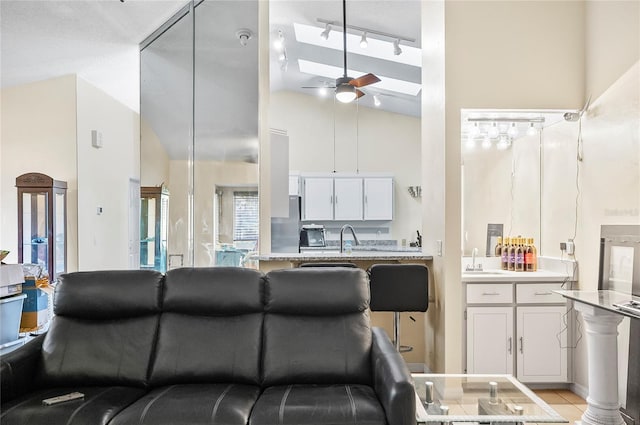 50 Florida Park Dr, Palm Coast, FL 32137 - living room with a ceiling fan, high vaulted ceiling, and track lighting
