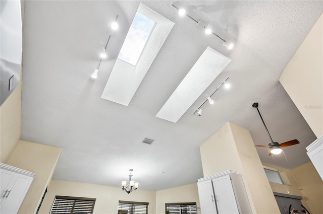 details featuring ceiling fan with notable chandelier and rail lighting